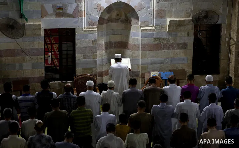 Palestinian Muslim worshippers pray overnight on July 2, 2016 at a Mosque in Gaza city on the occasion of Laylat al-Qadr which falls on the 27th day of the fasting month of Ramadan. Laylat al-Qadr, or Night of Destiny, m...