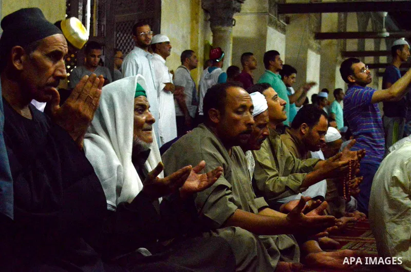 Egyptian muslim worshipers take part in Laylat Al Qadr prayers or Night of Power, in which the Muslim holy book of Koran was revealed to Prophet Mohammad by Allah on the 27th day of the holy fasting month of Ramadan at A...