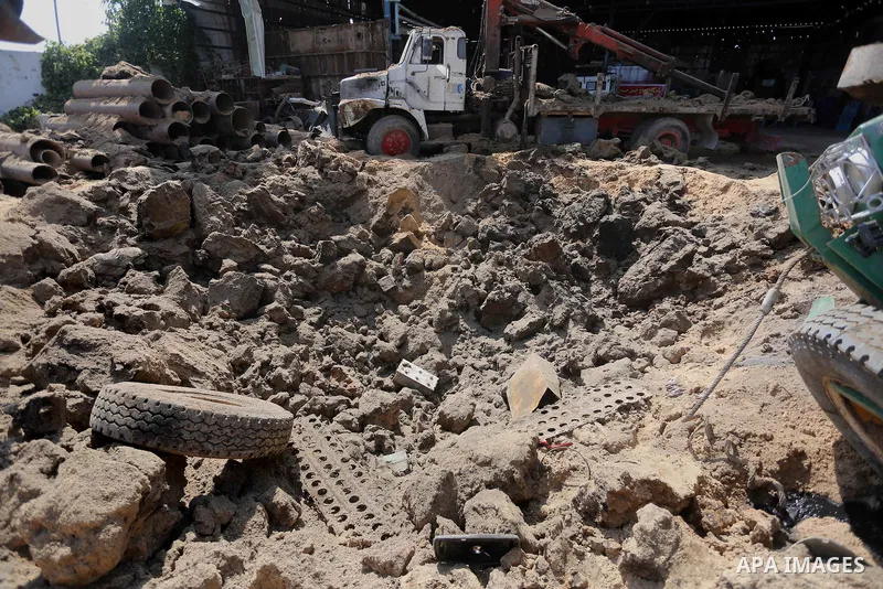 A Palestinian man looks at the damage following an Israeli air strike on a workshop in Gaza City on July 2, 2016. Israeli air strikes hit four sites in the Gaza Strip, causing damage but no injuries, officials said, afte...