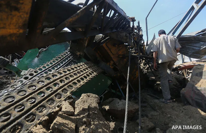 A Palestinian man looks at the damage following an Israeli air strike on a workshop in Gaza City on July 2, 2016. Israeli air strikes hit four sites in the Gaza Strip, causing damage but no injuries, officials said, afte...