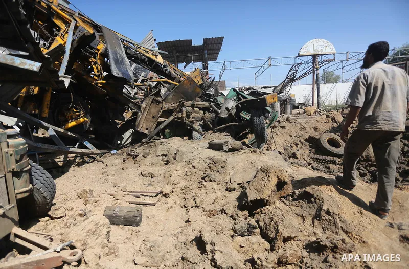 A Palestinian man looks at the damage following an Israeli air strike on a workshop in Gaza City on July 2, 2016. Israeli air strikes hit four sites in the Gaza Strip, causing damage but no injuries, officials said, afte...