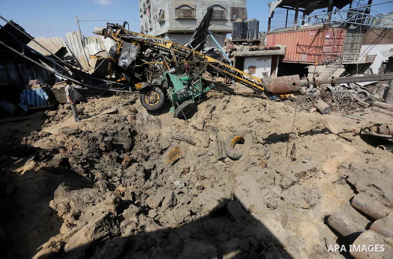 A Palestinian man looks at the damage following an Israeli air strike on a workshop in Gaza City on July 2, 2016. Israeli air strikes hit four sites in the Gaza Strip, causing damage but no injuries, officials said, afte...