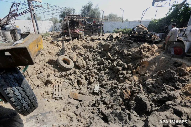 A Palestinian man looks at the damage following an Israeli air strike on a workshop in Gaza City on July 2, 2016. Israeli air strikes hit four sites in the Gaza Strip, causing damage but no injuries, officials said, afte...