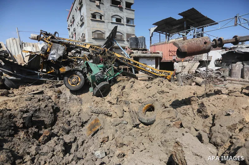 A Palestinian man looks at the damage following an Israeli air strike on a workshop in Gaza City on July 2, 2016. Israeli air strikes hit four sites in the Gaza Strip, causing damage but no injuries, officials said, afte...