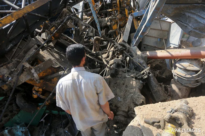 A Palestinian man looks at the damage following an Israeli air strike on a workshop in Gaza City on July 2, 2016. Israeli air strikes hit four sites in the Gaza Strip, causing damage but no injuries, officials said, afte...