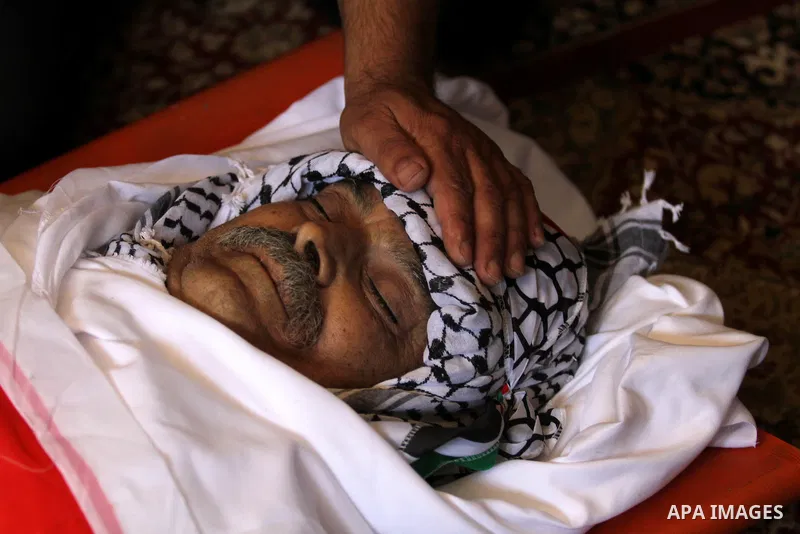 Relatives of Palestinian Tayseer Habash, who died from tear gas fired by Israeli security forces during clashes, mourn next to his body during his funeral on July 2, 2016 in the West Bank city of Nablus. Habash, 63, died...