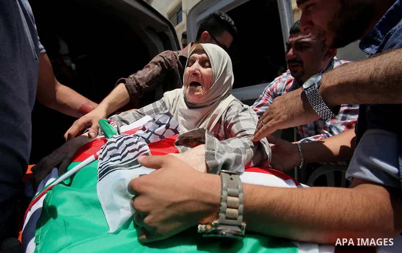 The mother of Palestinian Tayseer Habash, who died from tear gas fired by Israeli security forces during clashes, mourns next to his body during his funeral on July 2, 2016 in the West Bank city of Nablus. Habash, 63, di...