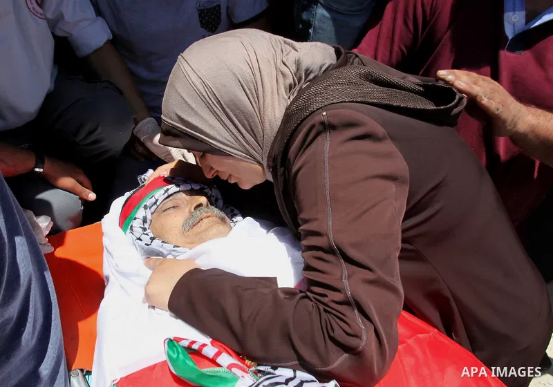 Relatives of Palestinian Tayseer Habash, who died from tear gas fired by Israeli security forces during clashes, mourn next to his body during his funeral on July 2, 2016 in the West Bank city of Nablus. Habash, 63, died...