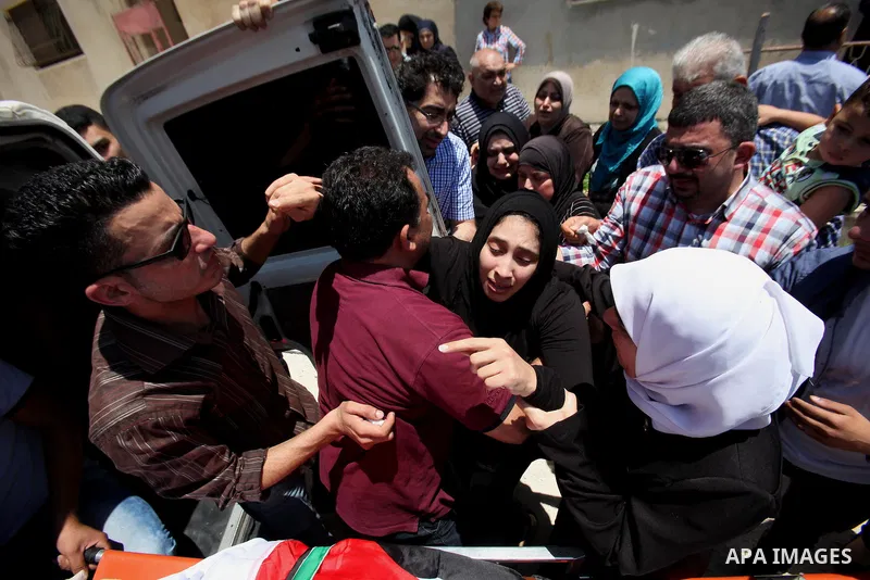 Relatives of Palestinian Tayseer Habash, who died from tear gas fired by Israeli security forces during clashes, mourn next to his body during his funeral on July 2, 2016 in the West Bank city of Nablus. Habash, 63, died...