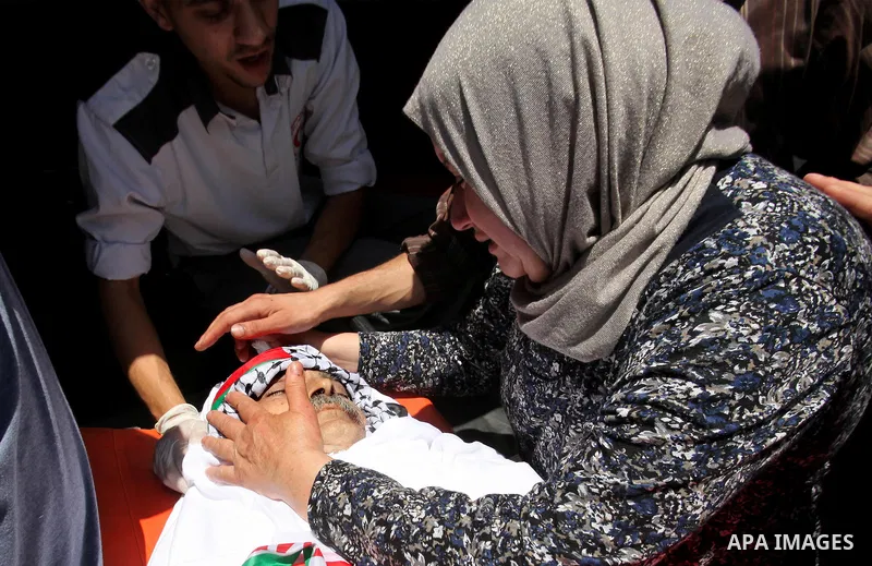 Relatives of Palestinian Tayseer Habash, who died from tear gas fired by Israeli security forces during clashes, mourn next to his body during his funeral on July 2, 2016 in the West Bank city of Nablus. Habash, 63, died...