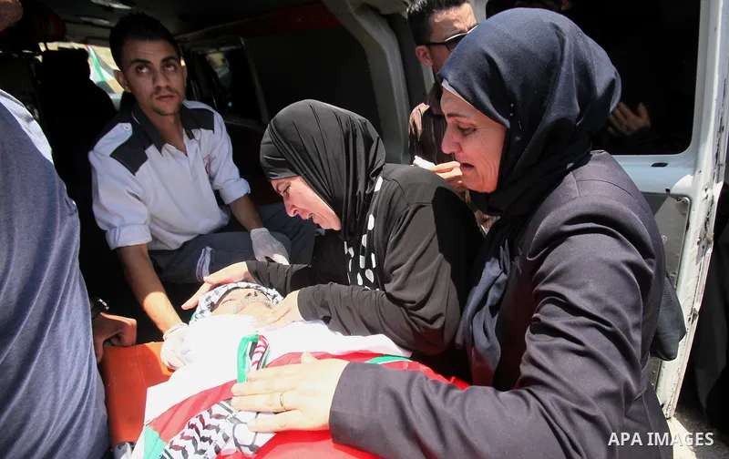 Relatives of Palestinian Tayseer Habash, who died from tear gas fired by Israeli security forces during clashes, mourn next to his body during his funeral on July 2, 2016 in the West Bank city of Nablus. Habash, 63, died...