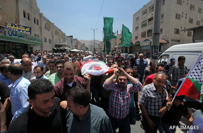 Mourners carry the body of Palestinian Tayseer Habash, who died from tear gas fired by Israeli security forces during clashes, during his funeral on July 2, 2016 in the West Bank city of Nablus. Habash, 63, died on July...