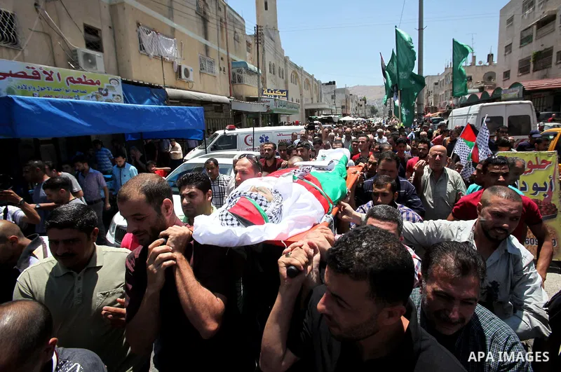 Mourners carry the body of Palestinian Tayseer Habash, who died from tear gas fired by Israeli security forces during clashes, during his funeral on July 2, 2016 in the West Bank city of Nablus. Habash, 63, died on July...