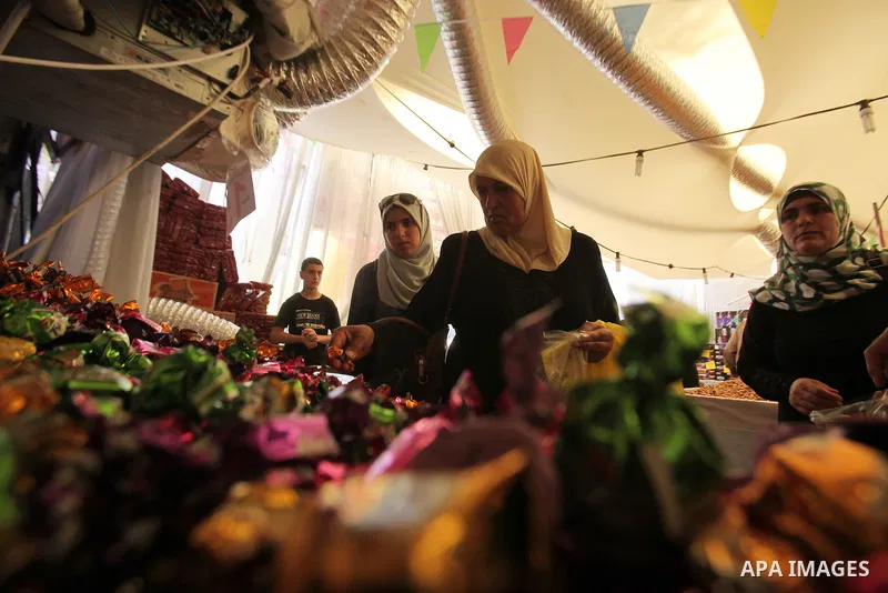 Palestinians shop at a market ahead of the Eid al-Fitr holiday, in the West Bank city of Nablus, on July 3, 2016. Eid al-Fitr marks the end of Muslim's holy fasting month of Ramadan when faithfuls abstain from eating, dr...