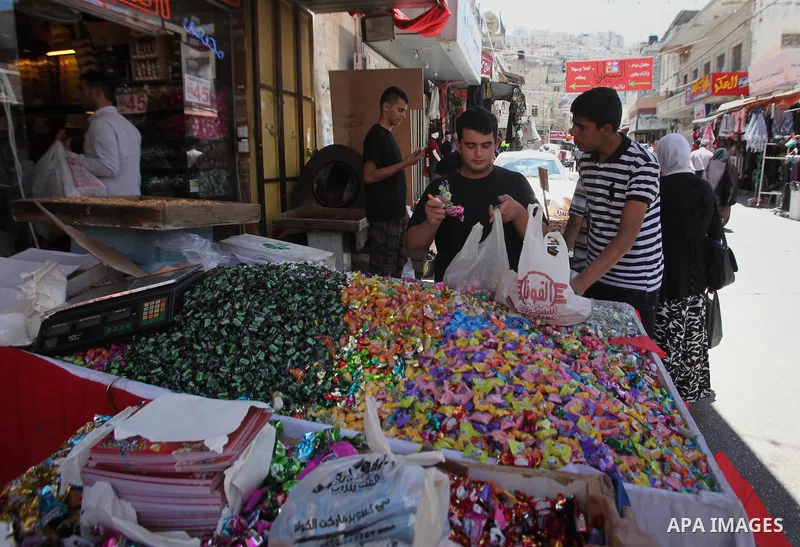 Palestinians shop at a market ahead of the Eid al-Fitr holiday, in the West Bank city of Nablus, on July 3, 2016. Eid al-Fitr marks the end of Muslim's holy fasting month of Ramadan when faithfuls abstain from eating, dr...