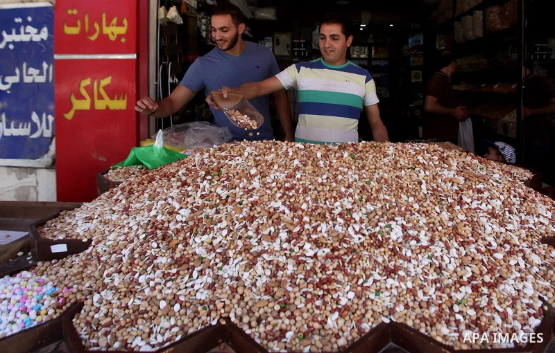 Palestinians shop at a market ahead of the Eid al-Fitr holiday, in the West Bank city of Nablus, on July 3, 2016. Eid al-Fitr marks the end of Muslim's holy fasting month of Ramadan when faithfuls abstain from eating, dr...