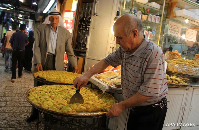 Palestinians shop at a market ahead of the Eid al-Fitr holiday, in Jerusalem old city, on July 3, 2016. Eid al-Fitr marks the end of Muslim's holy fasting month of Ramadan when faithfuls abstain from eating, drinking, sm...