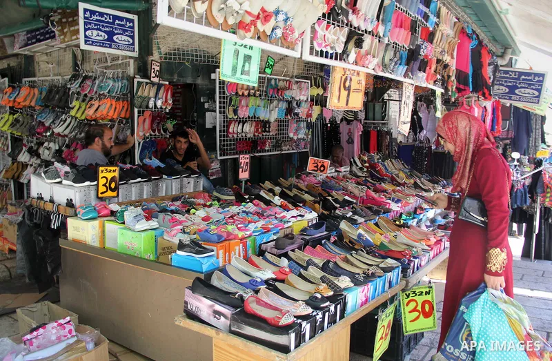 Palestinians shop at a market ahead of the Eid al-Fitr holiday, in Jerusalem old city, on July 3, 2016. Eid al-Fitr marks the end of Muslim's holy fasting month of Ramadan when faithfuls abstain from eating, drinking, sm...