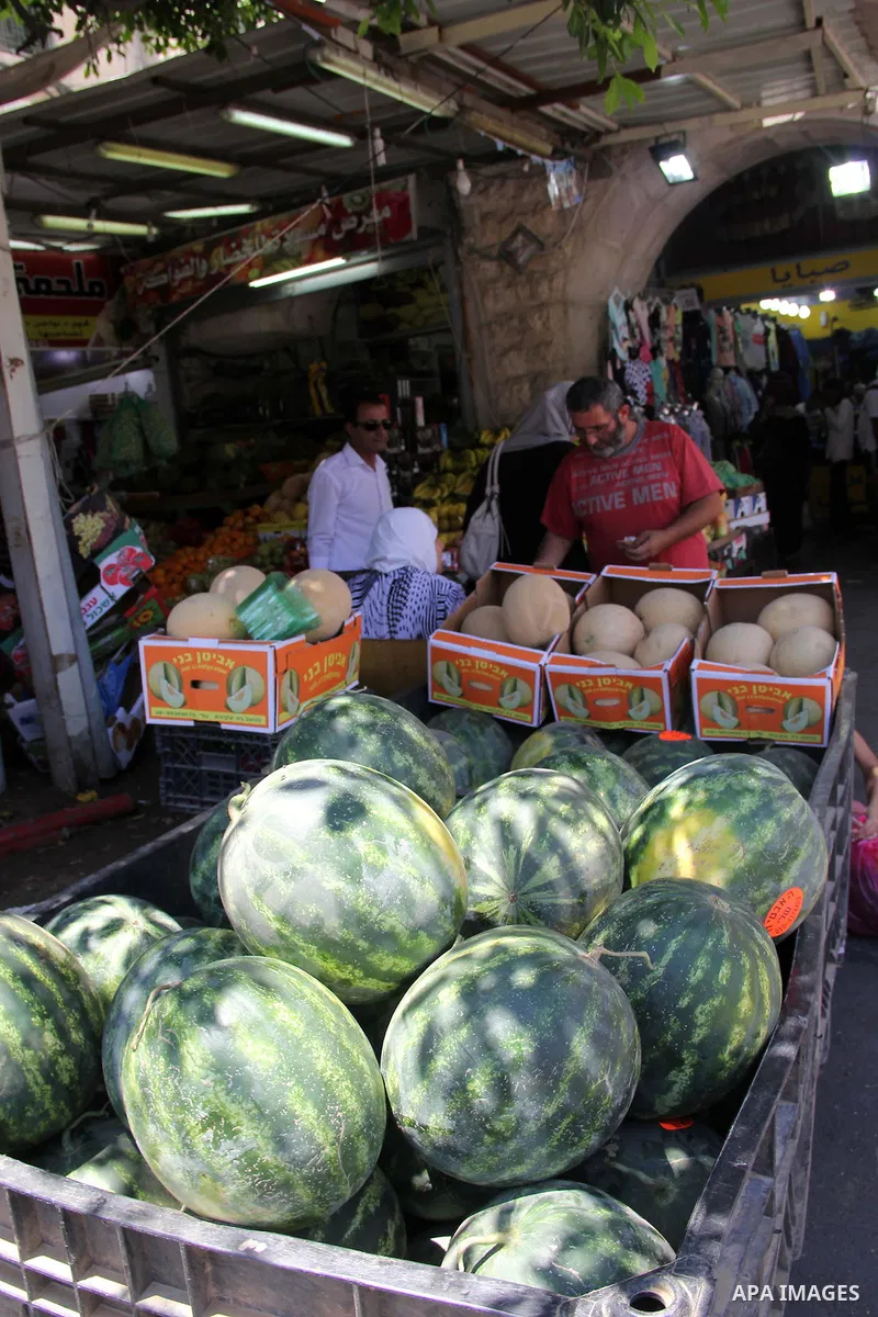 Palestinians shop at a market ahead of the Eid al-Fitr holiday, in Jerusalem old city, on July 3, 2016. Eid al-Fitr marks the end of Muslim's holy fasting month of Ramadan when faithfuls abstain from eating, drinking, sm...