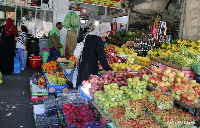 Palestinians shop at a market ahead of the Eid al-Fitr holiday, in Jerusalem old city, on July 3, 2016. Eid al-Fitr marks the end of Muslim's holy fasting month of Ramadan when faithfuls abstain from eating, drinking, sm...