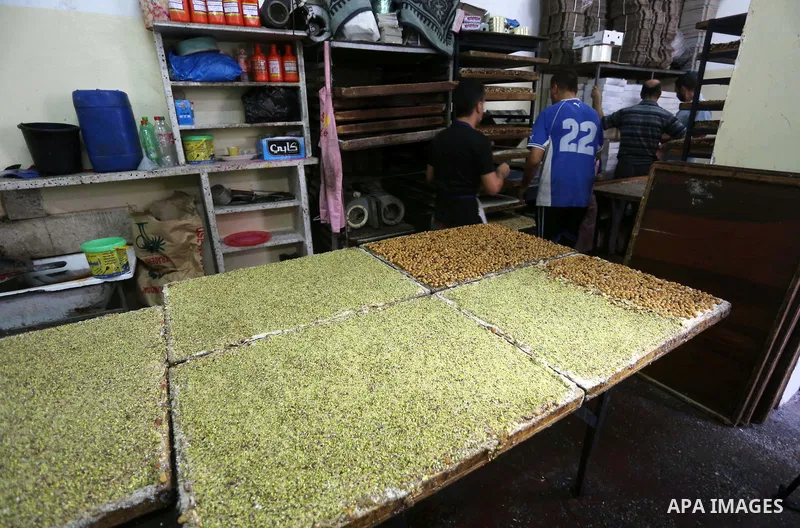 Palestinians prepare sweet known in Arabic as "Halkoum" ahead of the Eid al-Fitr holiday, in Gaza city, on July 3, 2016. Eid al-Fitr marks the end of Muslim's holy fasting month of Ramadan when faithfuls abstain from eat...