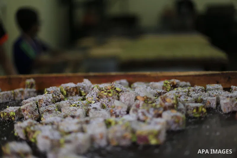 Palestinians prepare sweet known in Arabic as "Halkoum" ahead of the Eid al-Fitr holiday, in Gaza city, on July 3, 2016. Eid al-Fitr marks the end of Muslim's holy fasting month of Ramadan when faithfuls abstain from eat...