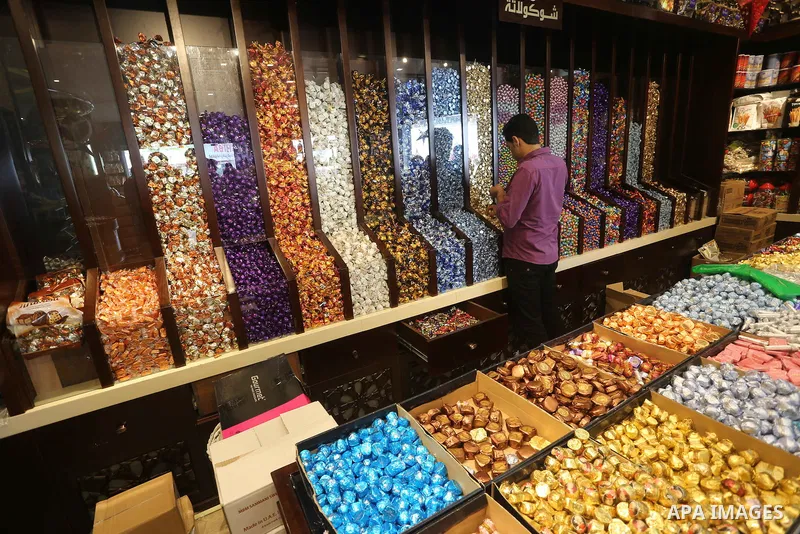 Palestinians sell chocolate at a shop ahead of the Eid al-Fitr holiday, in Gaza city, on July 3, 2016. Eid al-Fitr marks the end of Muslim's holy fasting month of Ramadan when faithfuls abstain from eating, drinking, smo...