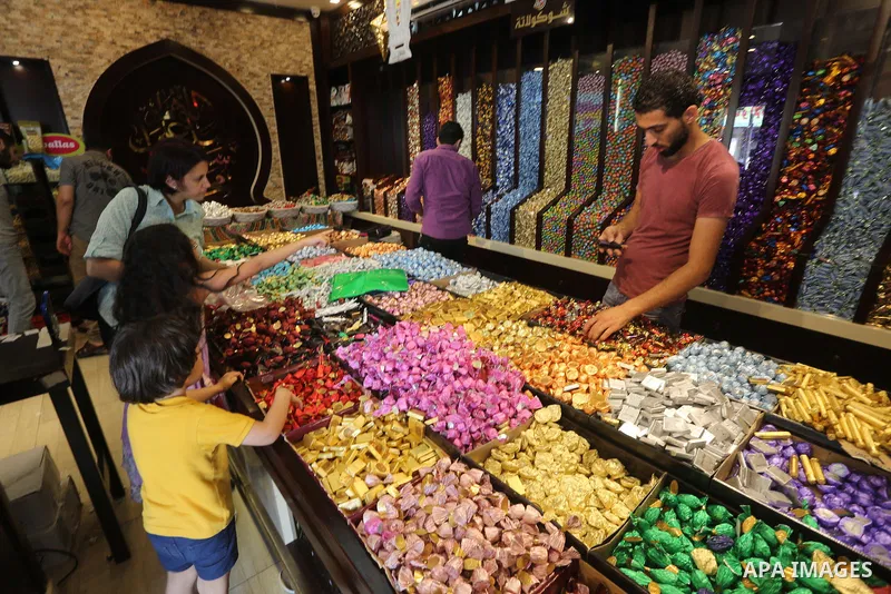 Palestinians sell chocolate at a shop ahead of the Eid al-Fitr holiday, in Gaza city, on July 3, 2016. Eid al-Fitr marks the end of Muslim's holy fasting month of Ramadan when faithfuls abstain from eating, drinking, smo...