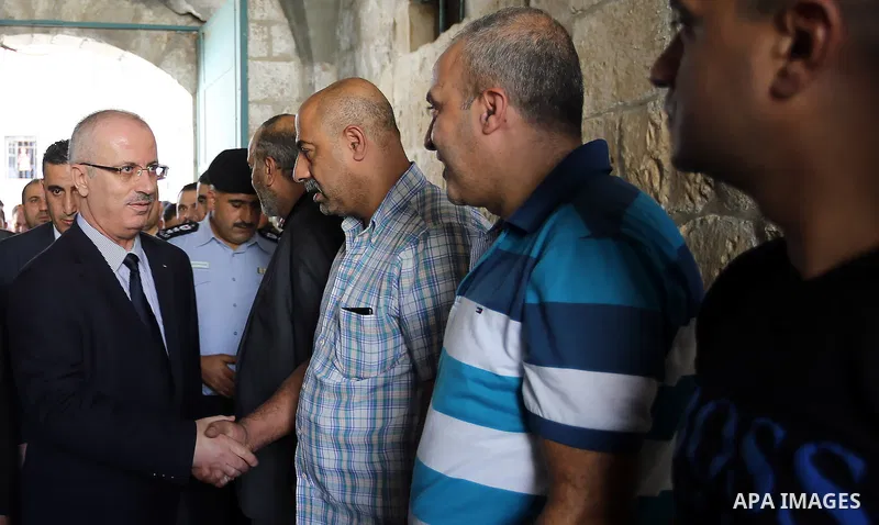 Palestinian Prime Minister Rami Hamdallah visits the mourning tent of Tayseer Habash, who died from tear gas fired by Israeli security forces during clashes, in the West Bank city of Nablus, on July 03, 2016. Photo by Pr...
