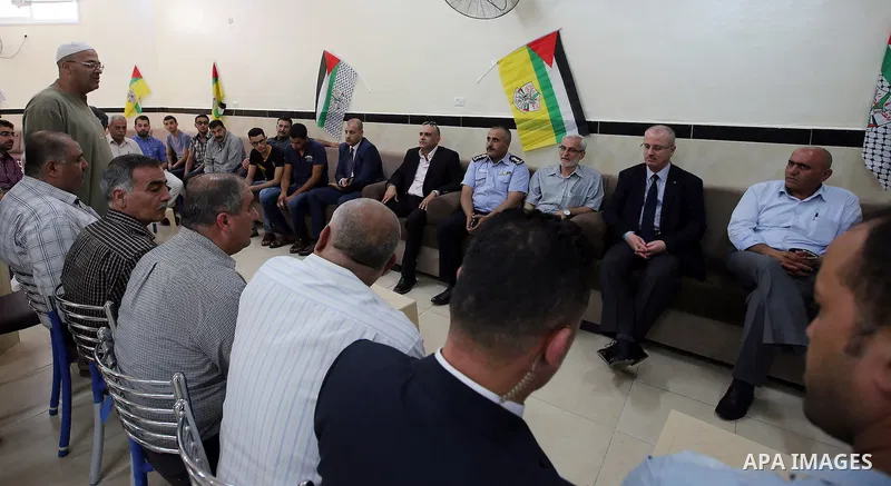Palestinian Prime Minister Rami Hamdallah visits the mourning tent of a member of Palestinian security forces Annan Tabouk, in the West Bank city of Nablus, on July 03, 2016. Photo by Prime Minister Office