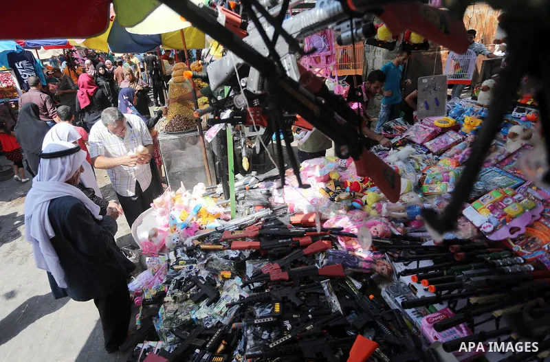 Palestinians shop at a market ahead of the Eid al-Fitr holiday, in Gaza city, on July 4, 2016. Eid al-Fitr marks the end of Muslim's holy fasting month of Ramadan when faithfuls abstain from eating, drinking, smoking and...