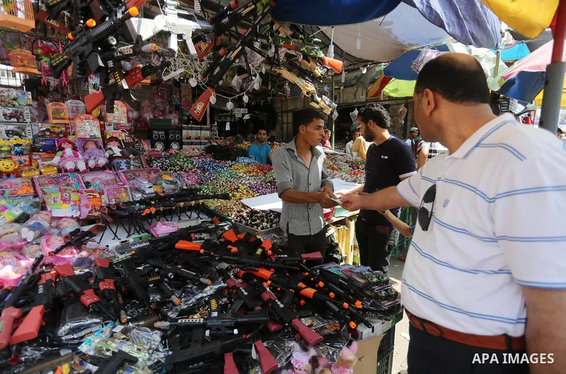 Palestinians shop at a market ahead of the Eid al-Fitr holiday, in Gaza city, on July 4, 2016. Eid al-Fitr marks the end of Muslim's holy fasting month of Ramadan when faithfuls abstain from eating, drinking, smoking and...