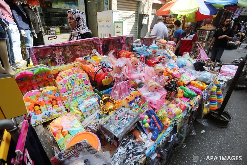 Palestinians shop at a market ahead of the Eid al-Fitr holiday, in Gaza city, on July 4, 2016. Eid al-Fitr marks the end of Muslim's holy fasting month of Ramadan when faithfuls abstain from eating, drinking, smoking and...