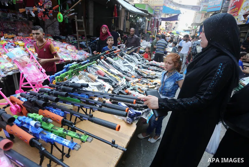 Palestinians shop at a market ahead of the Eid al-Fitr holiday, in Gaza city, on July 4, 2016. Eid al-Fitr marks the end of Muslim's holy fasting month of Ramadan when faithfuls abstain from eating, drinking, smoking and...
