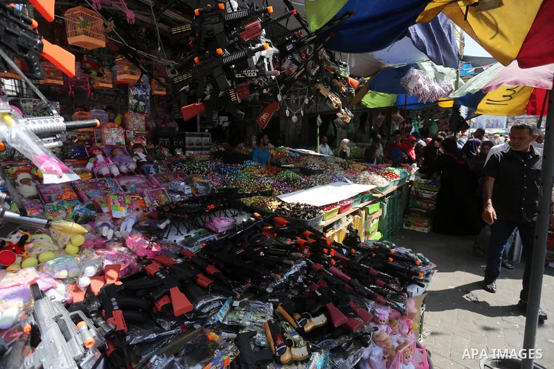 Palestinians shop at a market ahead of the Eid al-Fitr holiday, in Gaza city, on July 4, 2016. Eid al-Fitr marks the end of Muslim's holy fasting month of Ramadan when faithfuls abstain from eating, drinking, smoking and...
