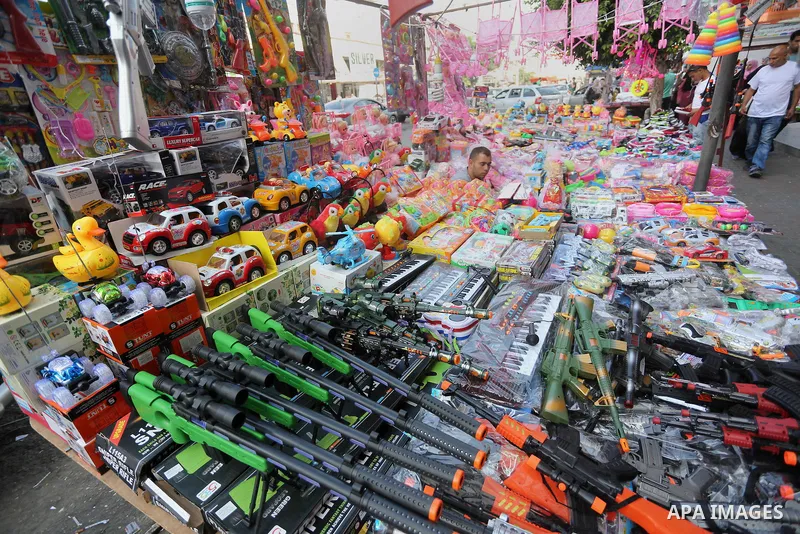 Palestinians shop at a market ahead of the Eid al-Fitr holiday, in Gaza city, on July 4, 2016. Eid al-Fitr marks the end of Muslim's holy fasting month of Ramadan when faithfuls abstain from eating, drinking, smoking and...