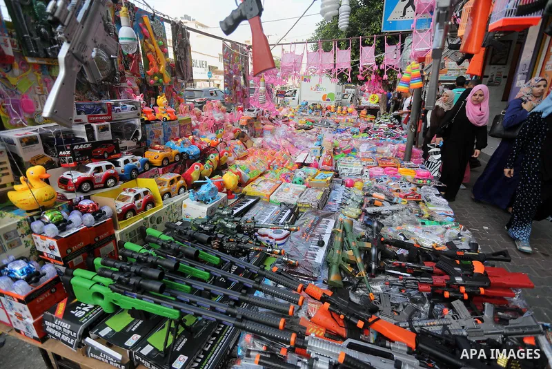 Palestinians shop at a market ahead of the Eid al-Fitr holiday, in Gaza city, on July 4, 2016. Eid al-Fitr marks the end of Muslim's holy fasting month of Ramadan when faithfuls abstain from eating, drinking, smoking and...