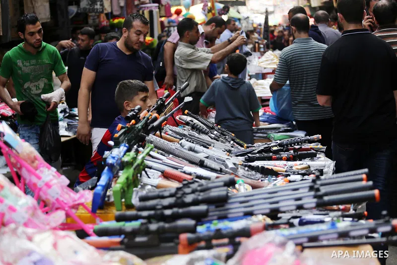 Palestinians shop at a market ahead of the Eid al-Fitr holiday, in Gaza city, on July 4, 2016. Eid al-Fitr marks the end of Muslim's holy fasting month of Ramadan when faithfuls abstain from eating, drinking, smoking and...