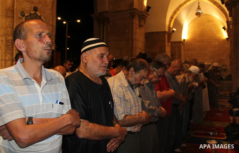 Palestinian Muslim worshippers perform "Taraweeh", nightly prayer of the month of Ramadan, inside al-Aqsa mosque, in Jerusalem's old city on July 03, 2016. Photo by Mahfouz Abu Turk