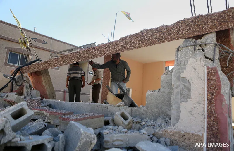 Palestinians inspect the damaged house of Issa Assaf, which was demolished by the Israeli army, in the West Bank refugee camp of Qalandia, at the outskirts of Ramallah, Monday, July 4, 2016. The Israeli army demolished t...