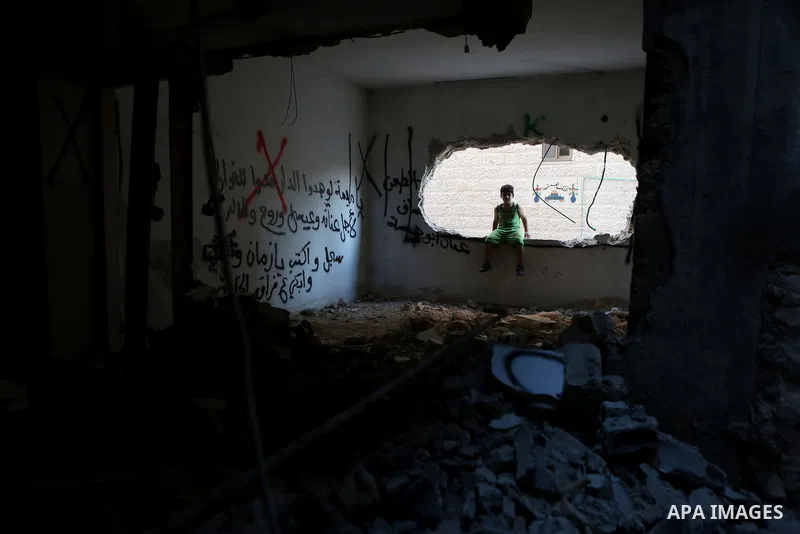 Palestinians inspect the damaged house of Issa Assaf, which was demolished by the Israeli army, in the West Bank refugee camp of Qalandia, at the outskirts of Ramallah, Monday, July 4, 2016. The Israeli army demolished t...