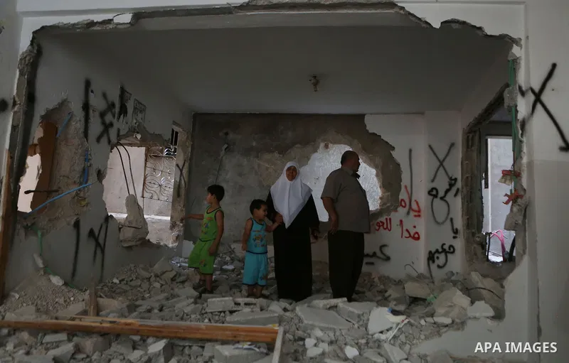 Palestinians inspect the damaged house of Issa Assaf, which was demolished by the Israeli army, in the West Bank refugee camp of Qalandia, at the outskirts of Ramallah, Monday, July 4, 2016. The Israeli army demolished t...
