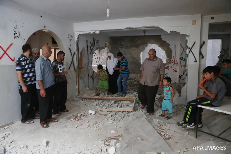 Palestinians inspect the damaged house of Issa Assaf, which was demolished by the Israeli army, in the West Bank refugee camp of Qalandia, at the outskirts of Ramallah, Monday, July 4, 2016. The Israeli army demolished t...