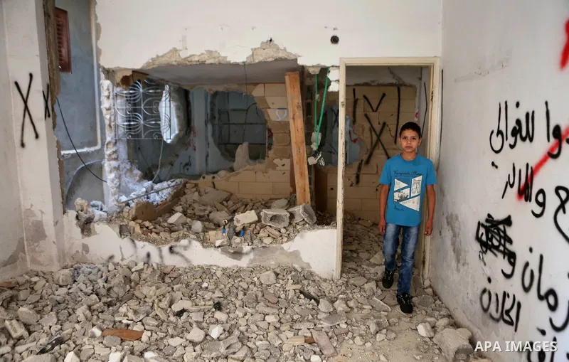Palestinians inspect the damaged house of Issa Assaf, which was demolished by the Israeli army, in the West Bank refugee camp of Qalandia, at the outskirts of Ramallah, Monday, July 4, 2016. The Israeli army demolished t...
