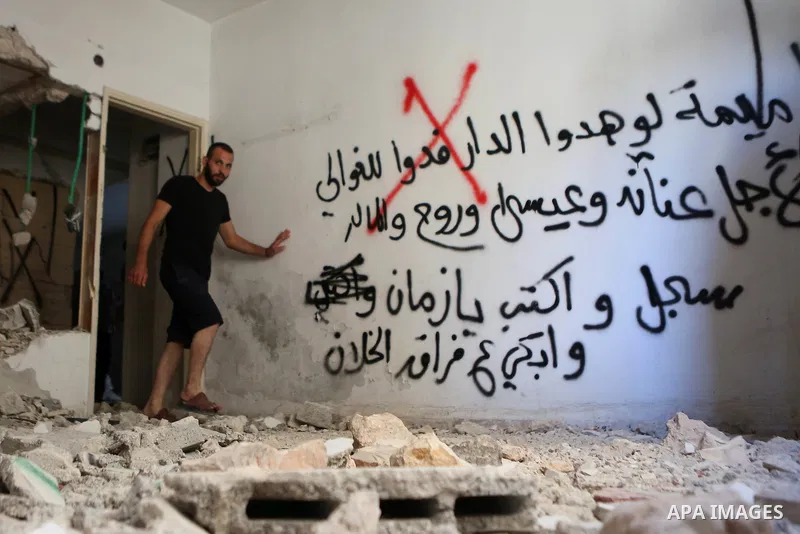 Palestinians inspect the damaged house of Issa Assaf, which was demolished by the Israeli army, in the West Bank refugee camp of Qalandia, at the outskirts of Ramallah, Monday, July 4, 2016. The Israeli army demolished t...