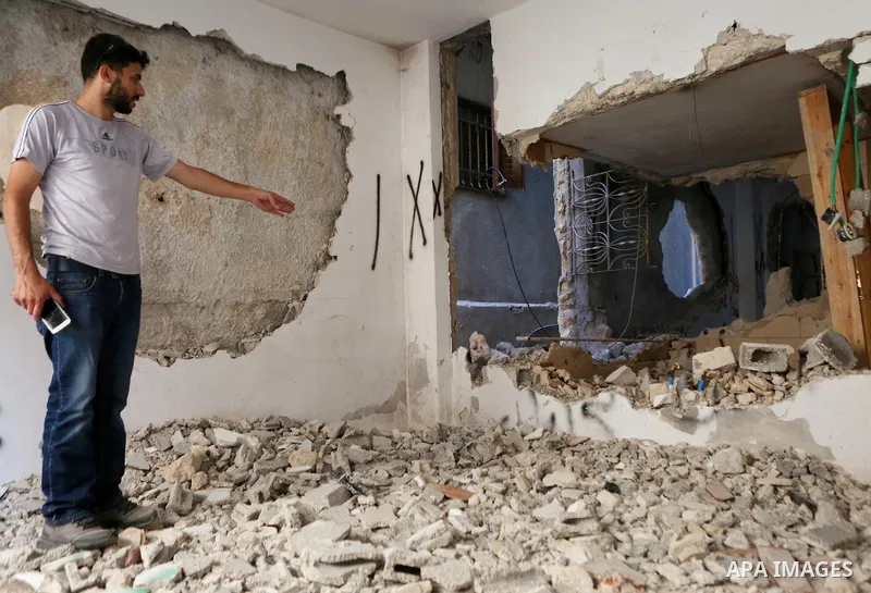 Palestinians inspect the damaged house of Issa Assaf, which was demolished by the Israeli army, in the West Bank refugee camp of Qalandia, at the outskirts of Ramallah, Monday, July 4, 2016. The Israeli army demolished t...