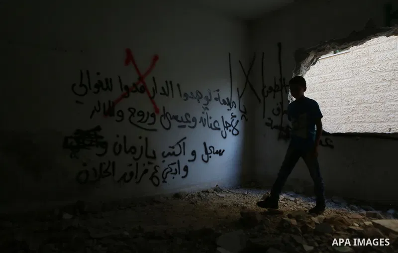 Palestinians inspect the damaged house of Issa Assaf, which was demolished by the Israeli army, in the West Bank refugee camp of Qalandia, at the outskirts of Ramallah, Monday, July 4, 2016. The Israeli army demolished t...