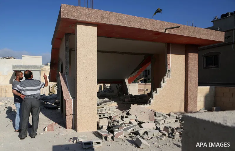 Palestinians inspect the damaged house of Anan Abu Habsa, which was demolished by the Israeli army, in the West Bank refugee camp of Qalandia, at the outskirts of Ramallah, Monday, July 4, 2016. The Israeli army demolish...