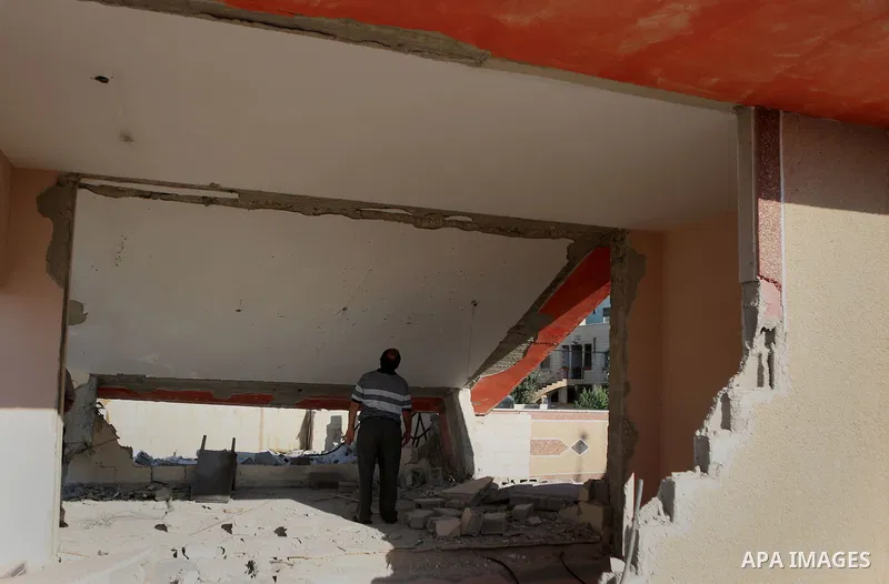 Palestinians inspect the damaged house of Anan Abu Habsa, which was demolished by the Israeli army, in the West Bank refugee camp of Qalandia, at the outskirts of Ramallah, Monday, July 4, 2016. The Israeli army demolish...