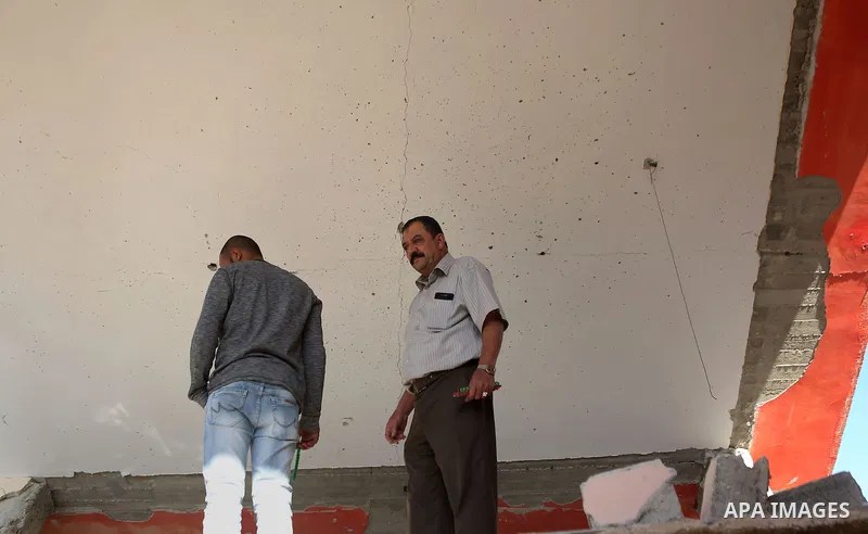 Palestinians inspect the damaged house of Anan Abu Habsa, which was demolished by the Israeli army, in the West Bank refugee camp of Qalandia, at the outskirts of Ramallah, Monday, July 4, 2016. The Israeli army demolish...